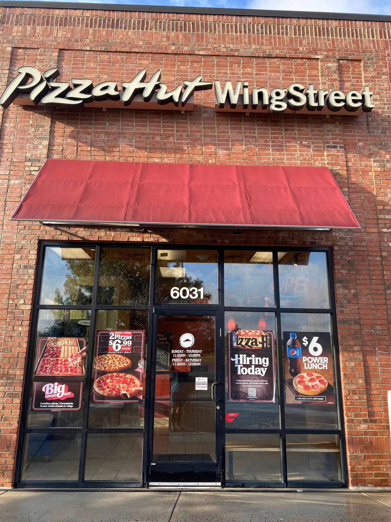 Commercial storefront with clean sidewalk after power washing services by a professional power washing company