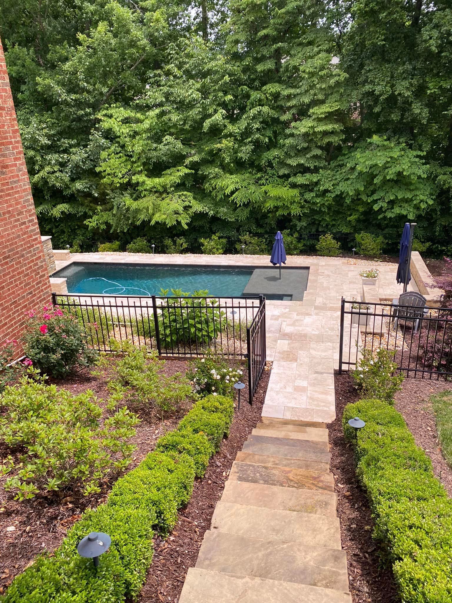 Clean stone walkway and pool area maintained with concrete cleaning and sealing services