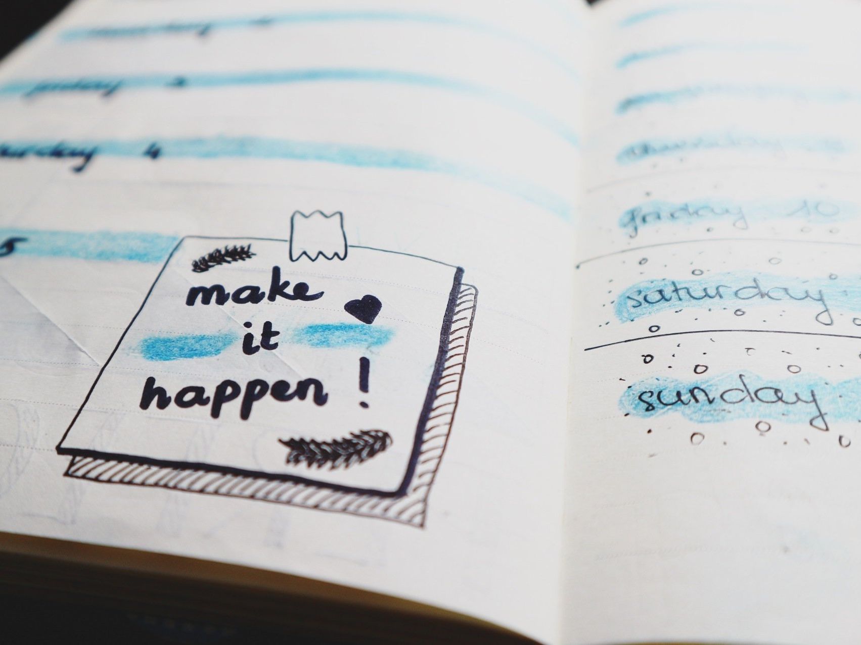 A notebook is open to a page that says make it happen