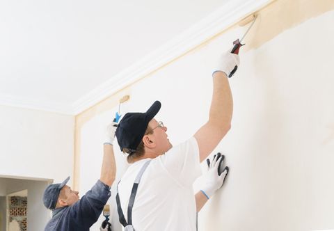 Interior Painting Services — Two Workers Painting A Wall In The Room in Seattle, WA
