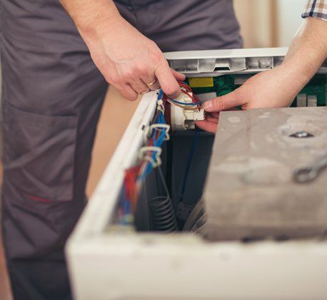 Home Repairs — Technician Repairing A Washing Machine in Seattle, WA