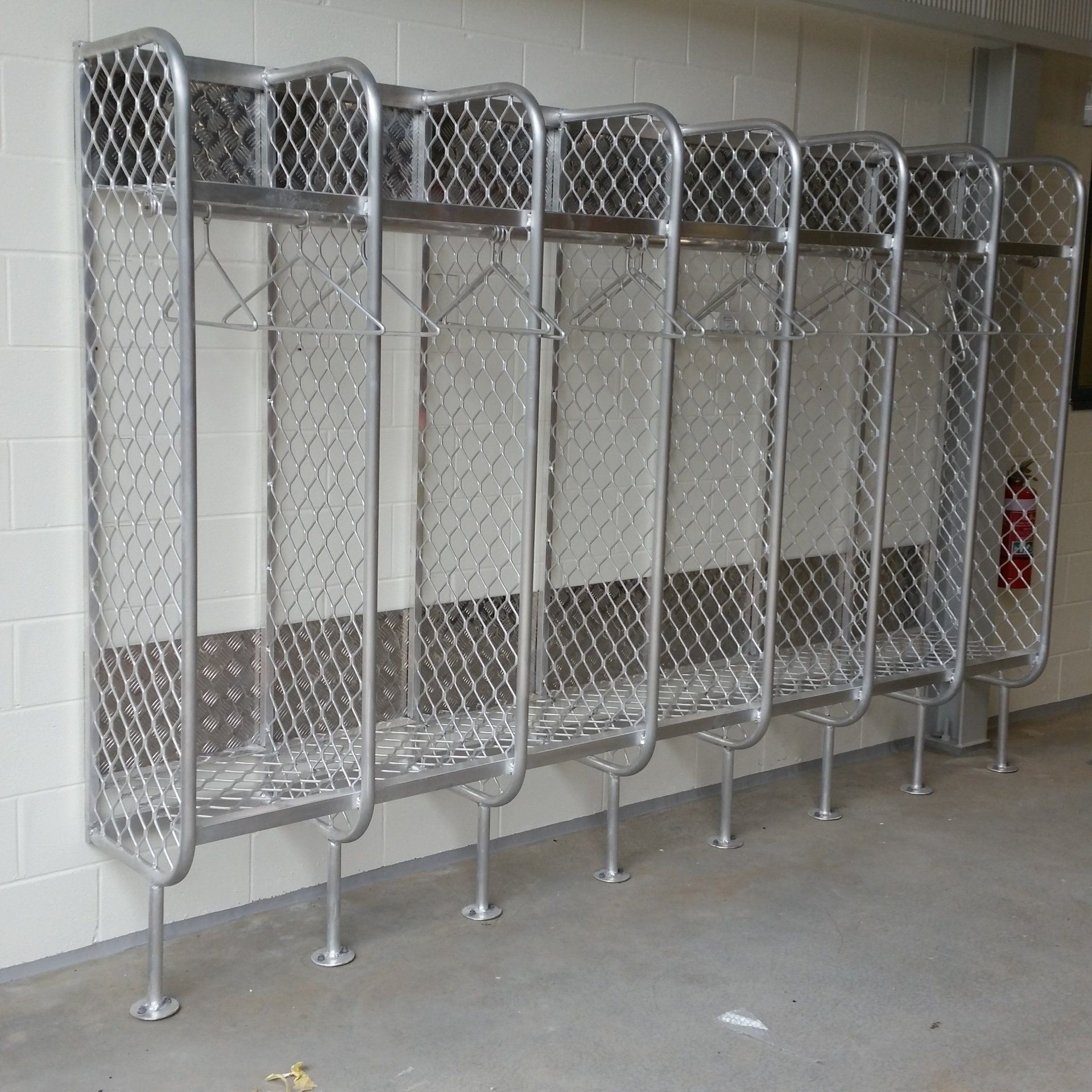 A row of lockers with a fire extinguisher in the background