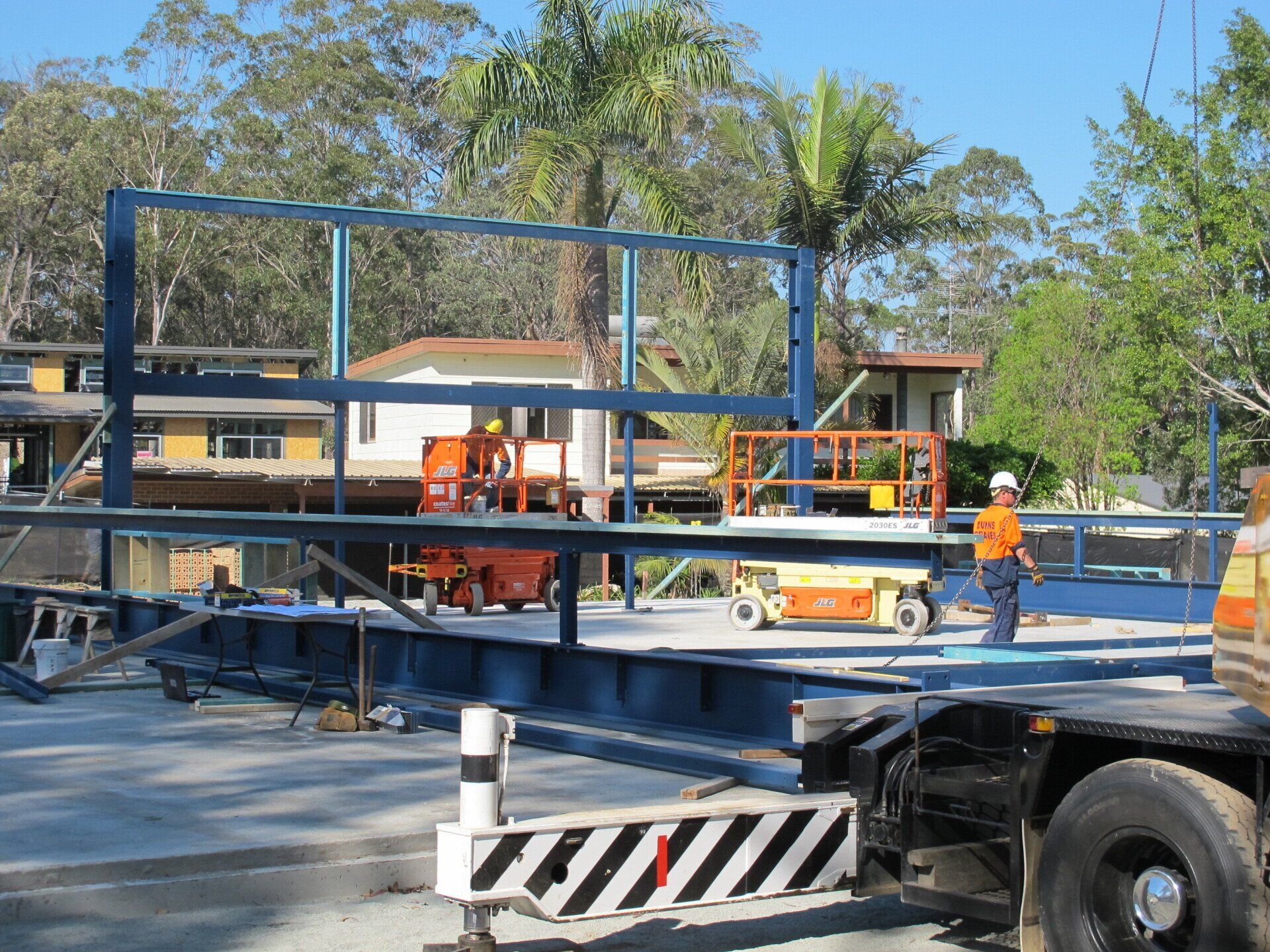 A man in a hard hat is working on a construction site