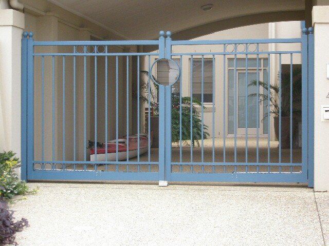 A blue gate with a circle in the middle of it