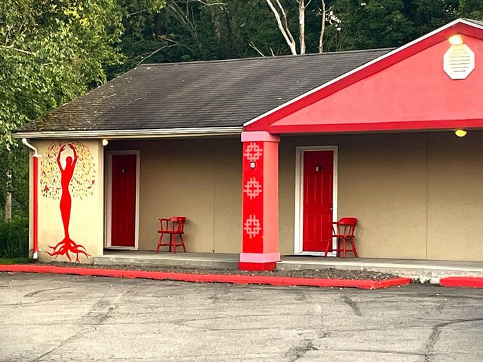 A building with a red roof and red doors