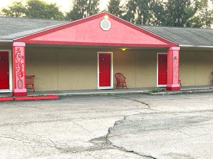 A building with a red roof and red doors