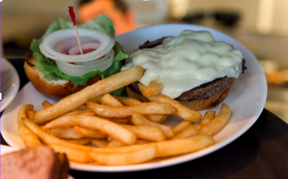 A white plate topped with a hamburger and french fries