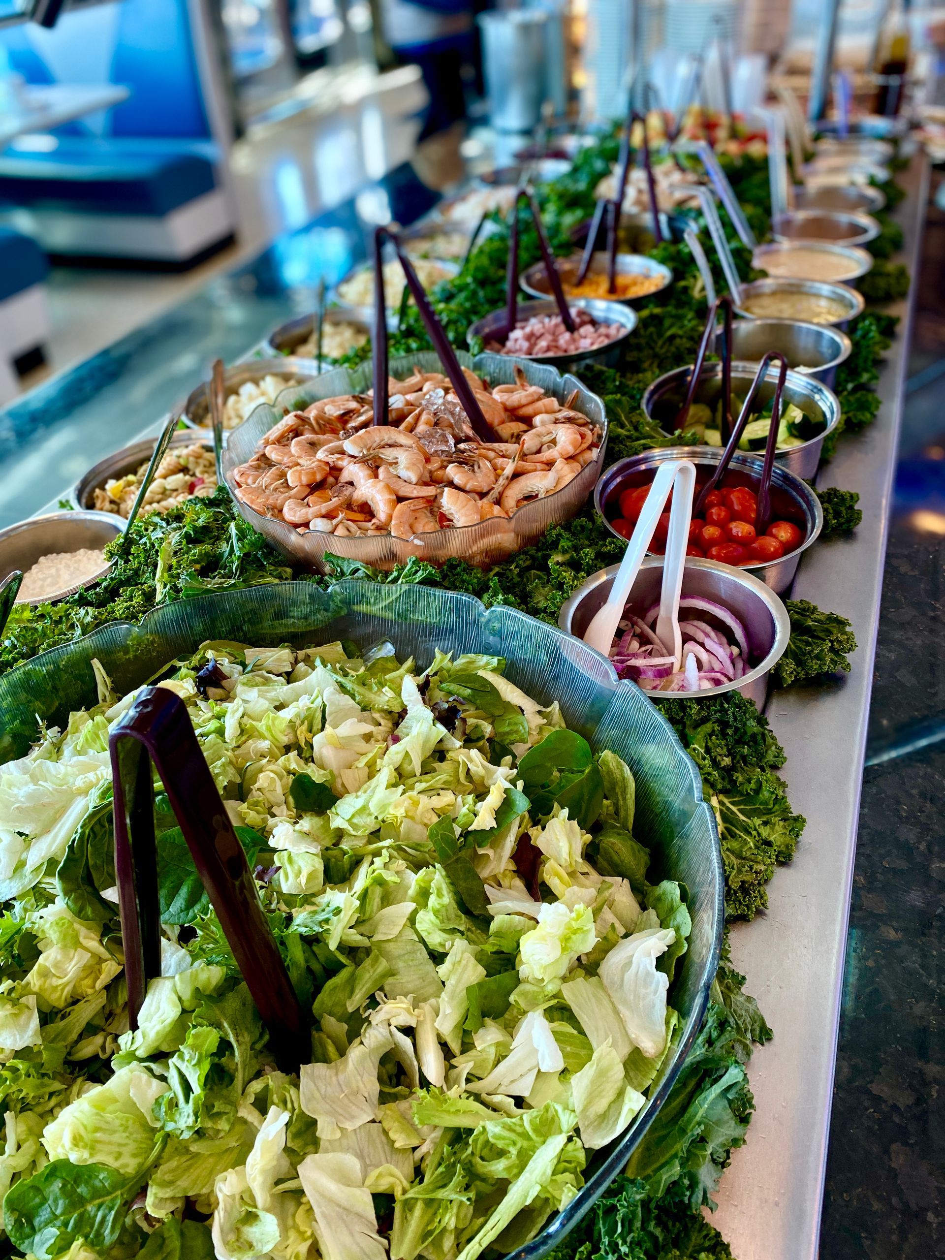 There are many different types of salads on the table.