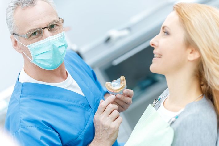 two doctors looking at dentures