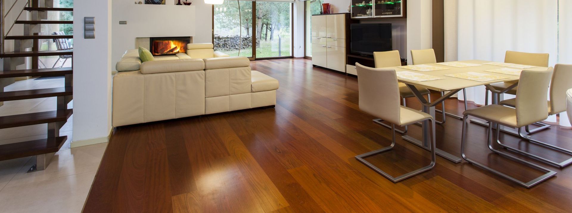 Refinished and restained wide mahogany plank flooring in a living/dining area