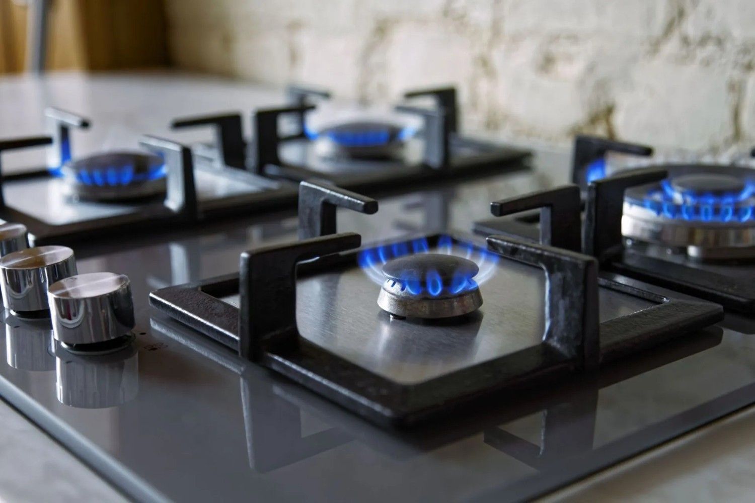 Gas Stove with A Fire Lit on It — Aqua Blue Plumbing Services in Coffs Harbour, NSW