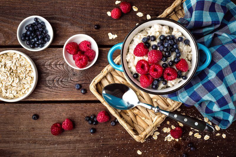 Assortment of berries and oats on a wooden table