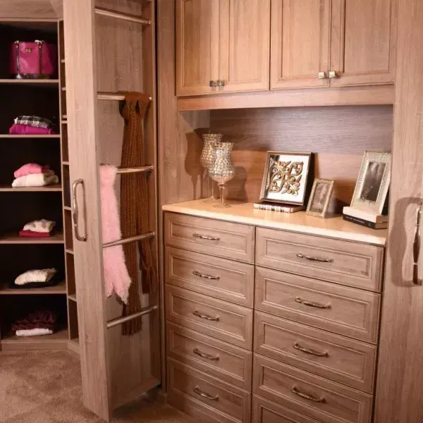 A walk in closet with lots of drawers and shelves