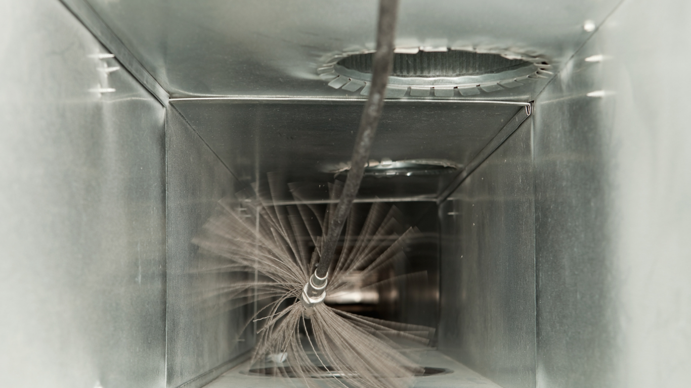 A close up of a duct with a brush in it.