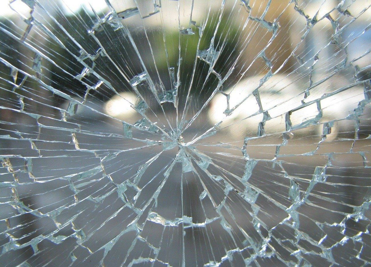 Image of a broken window that is shattered and cracked