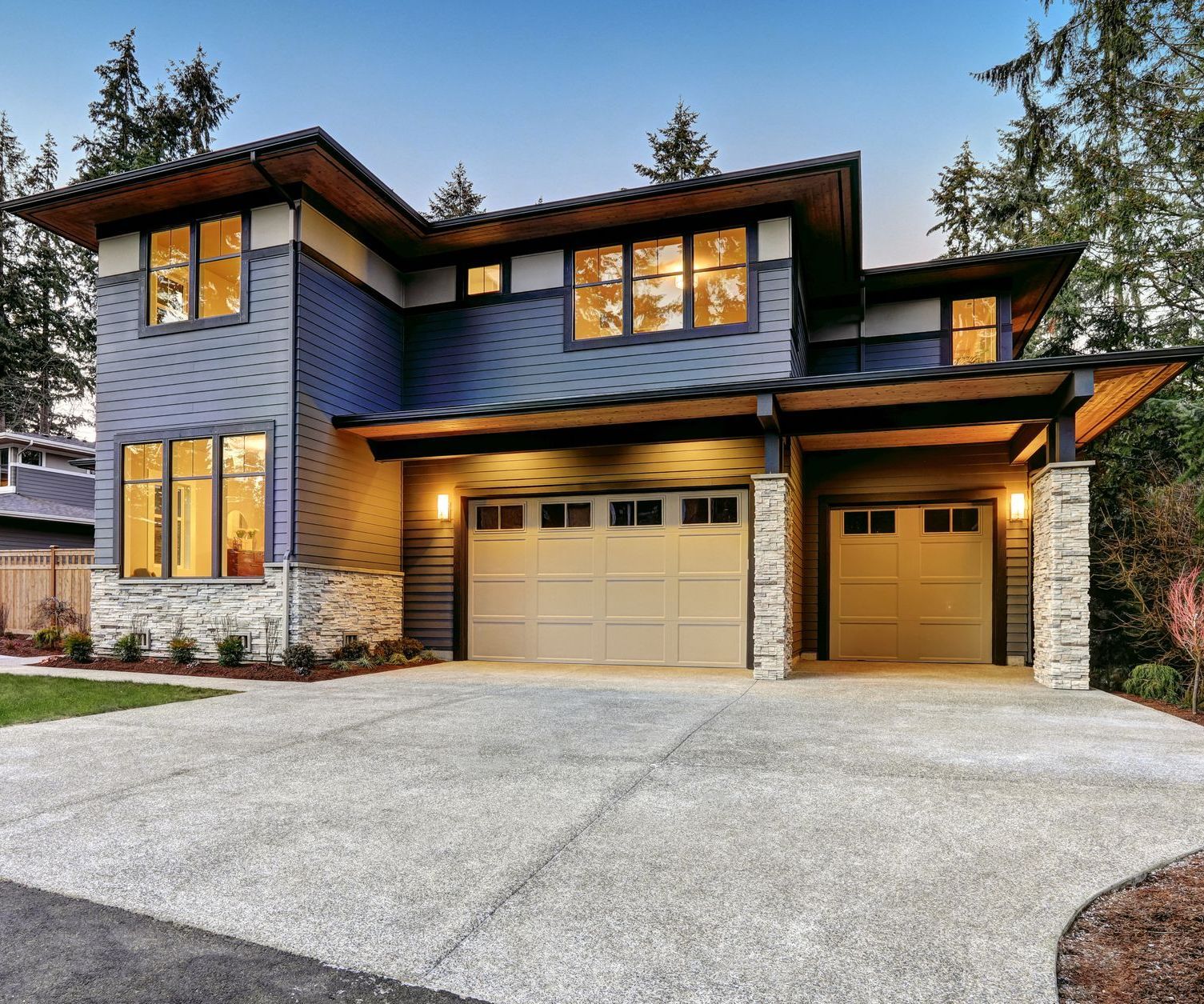 A large house with a garage and a driveway in front of it