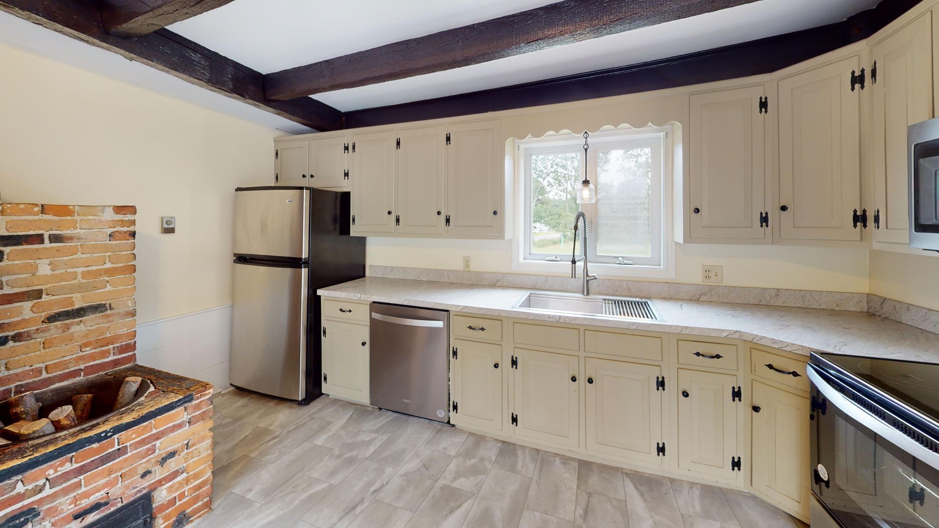 A kitchen with white cabinets and stainless steel appliances