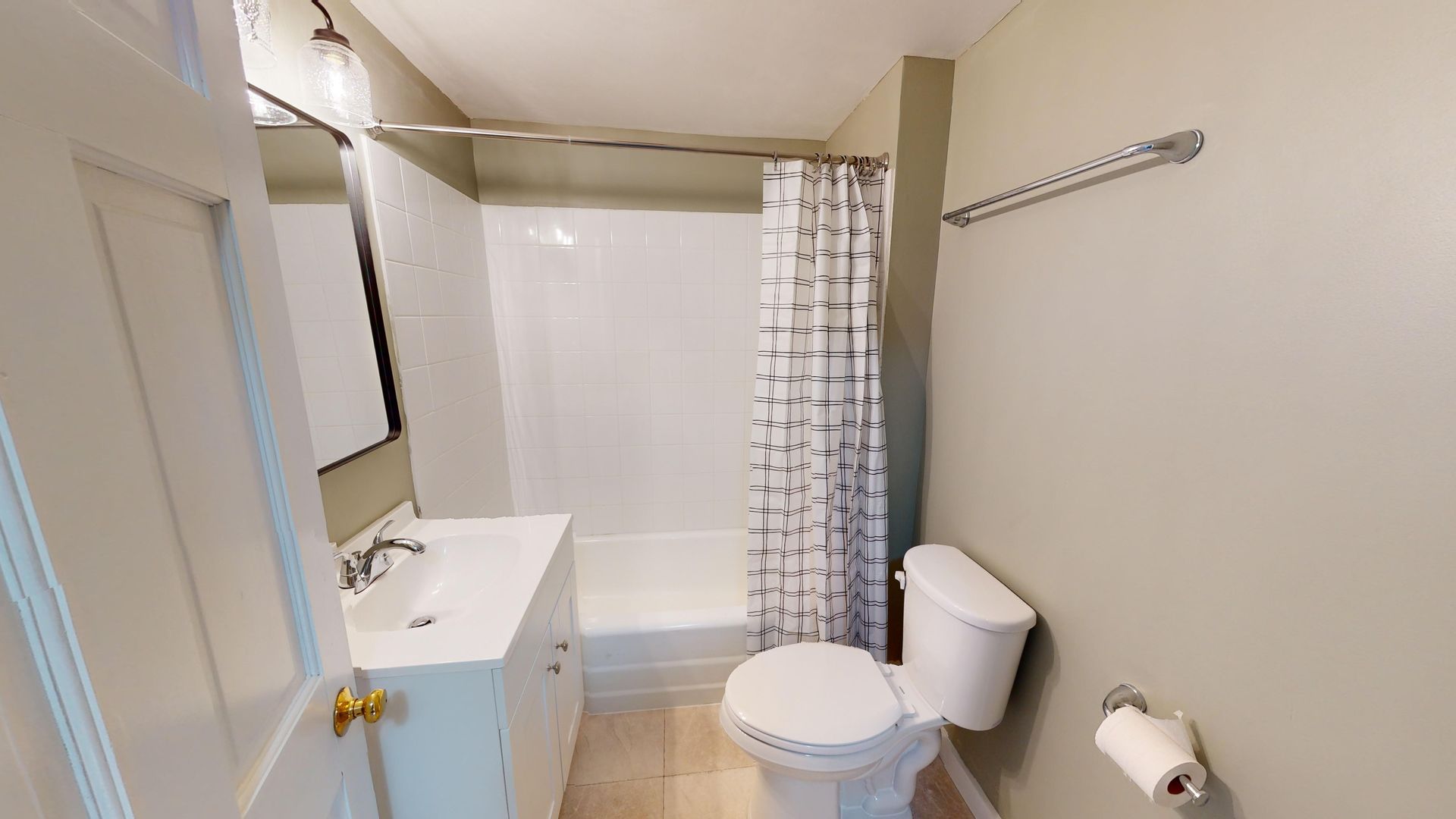 A bathroom with a toilet , sink , and shower.