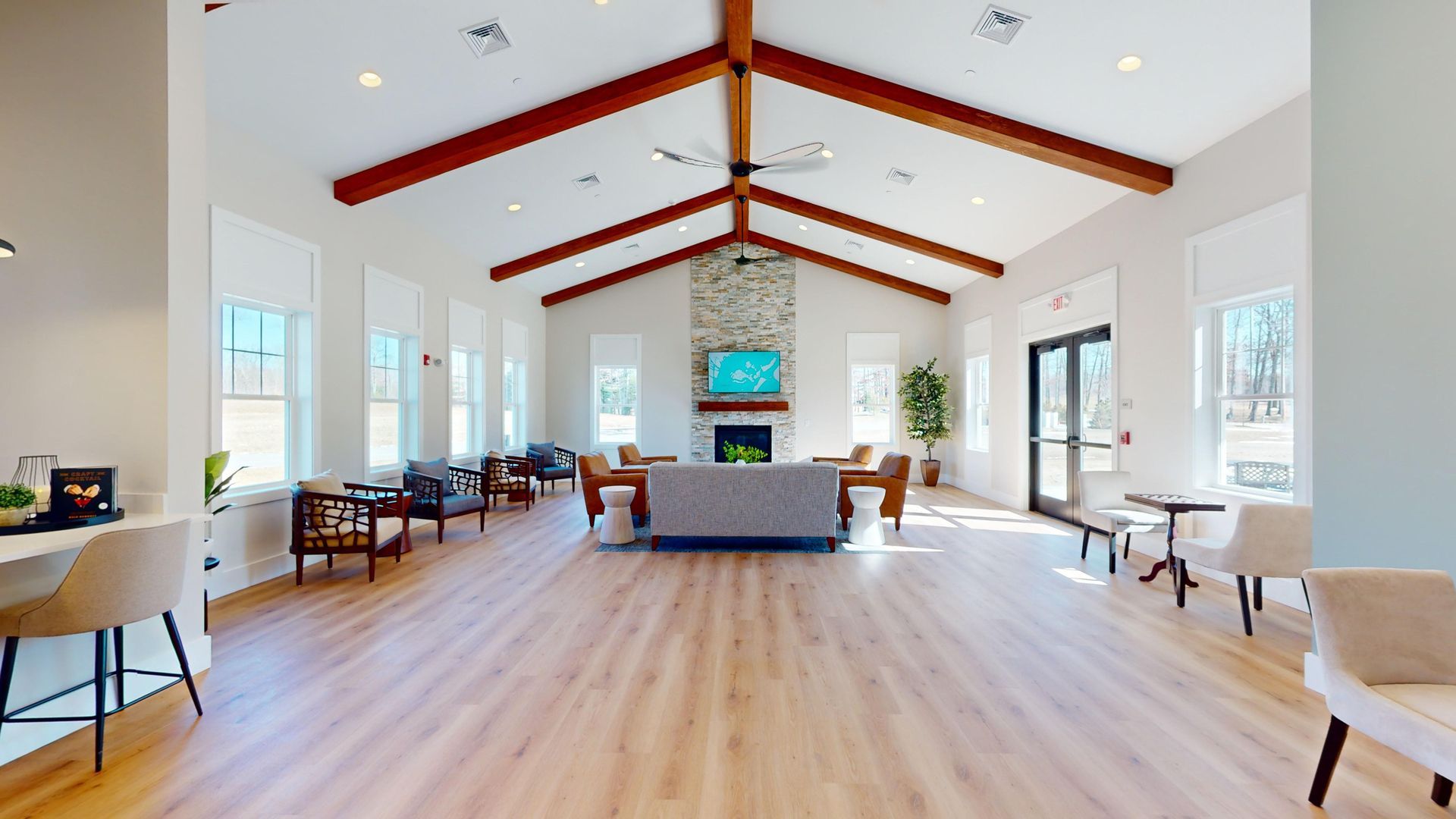 A large room with wooden floors and a fireplace.