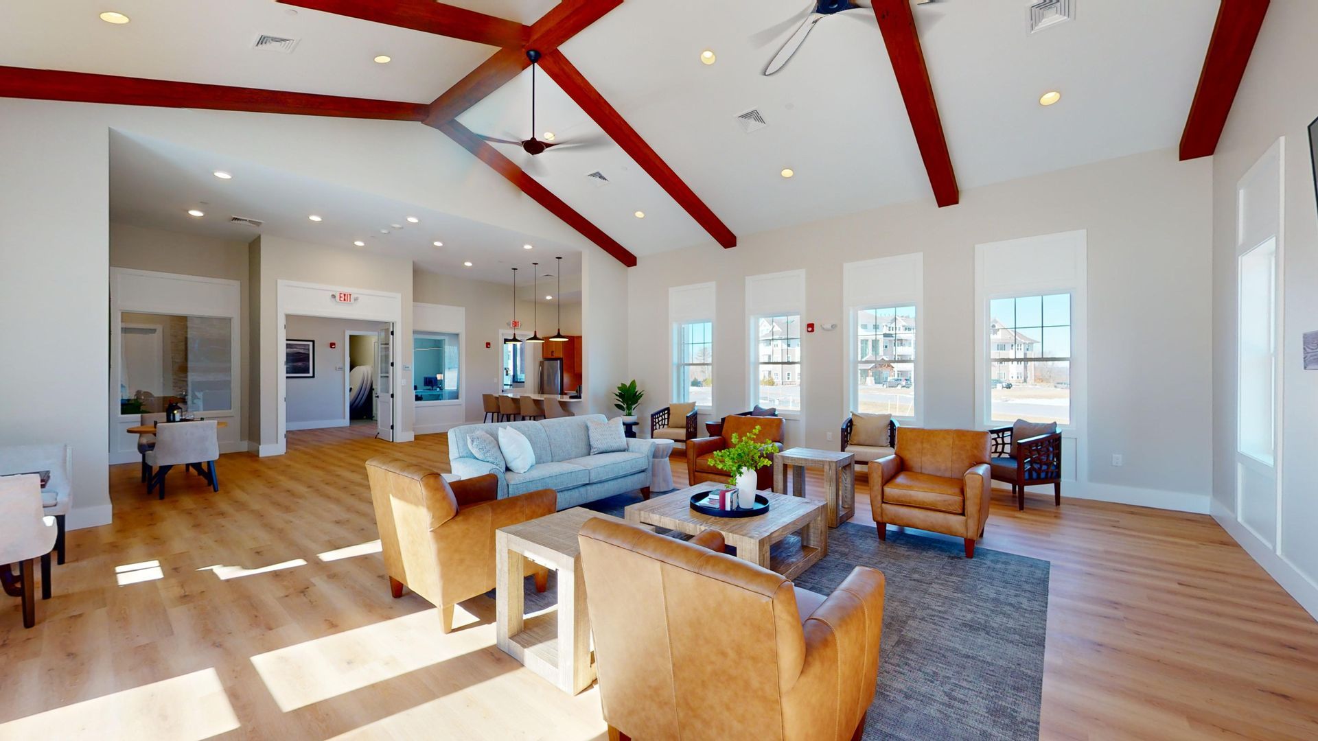 A great room filled with furniture and a ceiling fan.