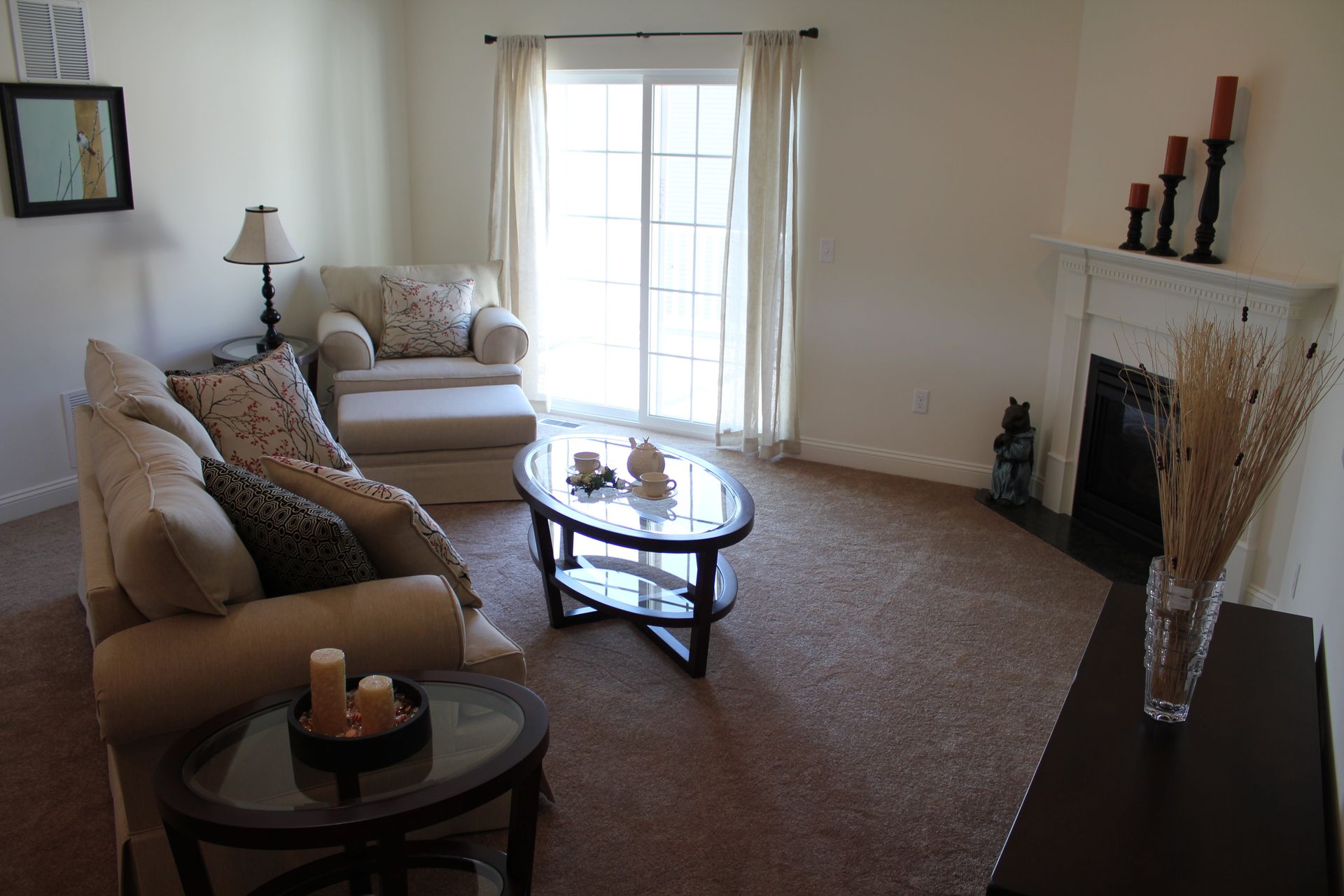 A living room with a couch a chair a coffee table and a fireplace