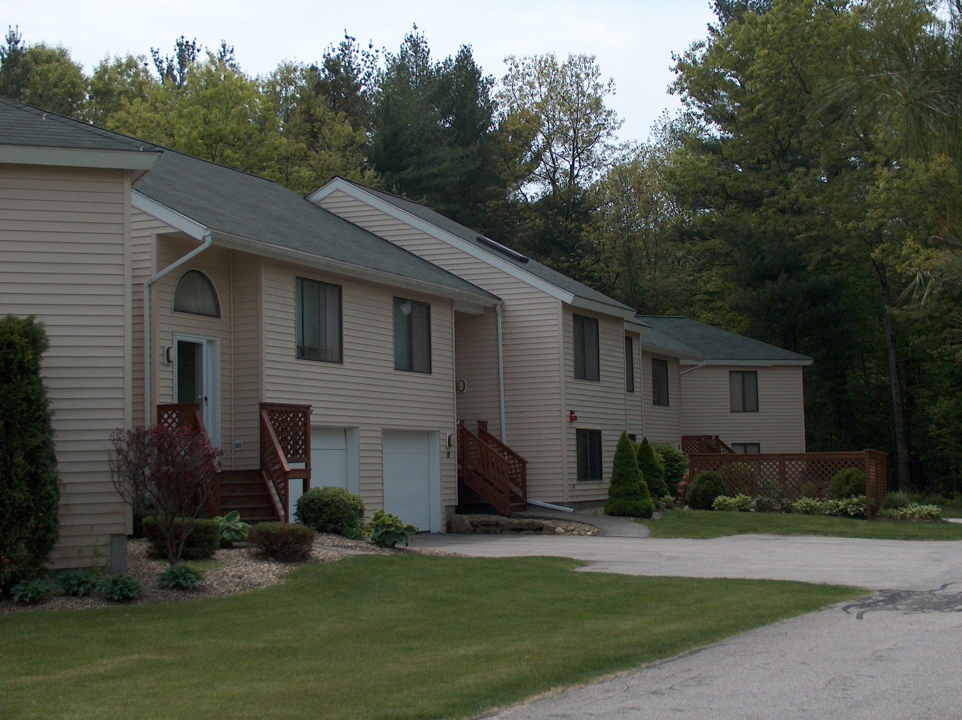 A row of houses in a residential area with trees in the background