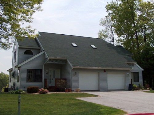 A house with two garage doors and two skylights on the roof