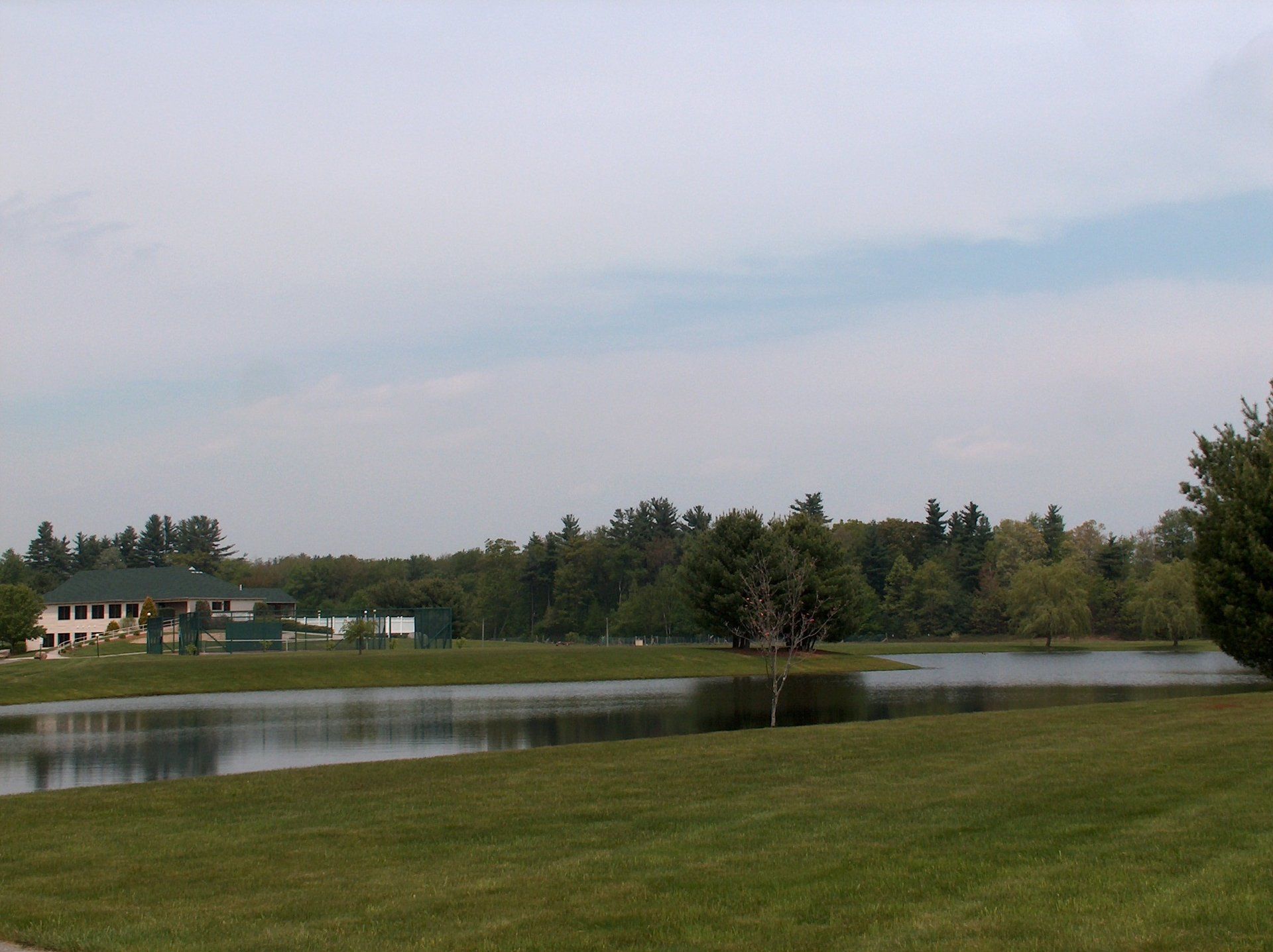 A large body of water with a house in the background