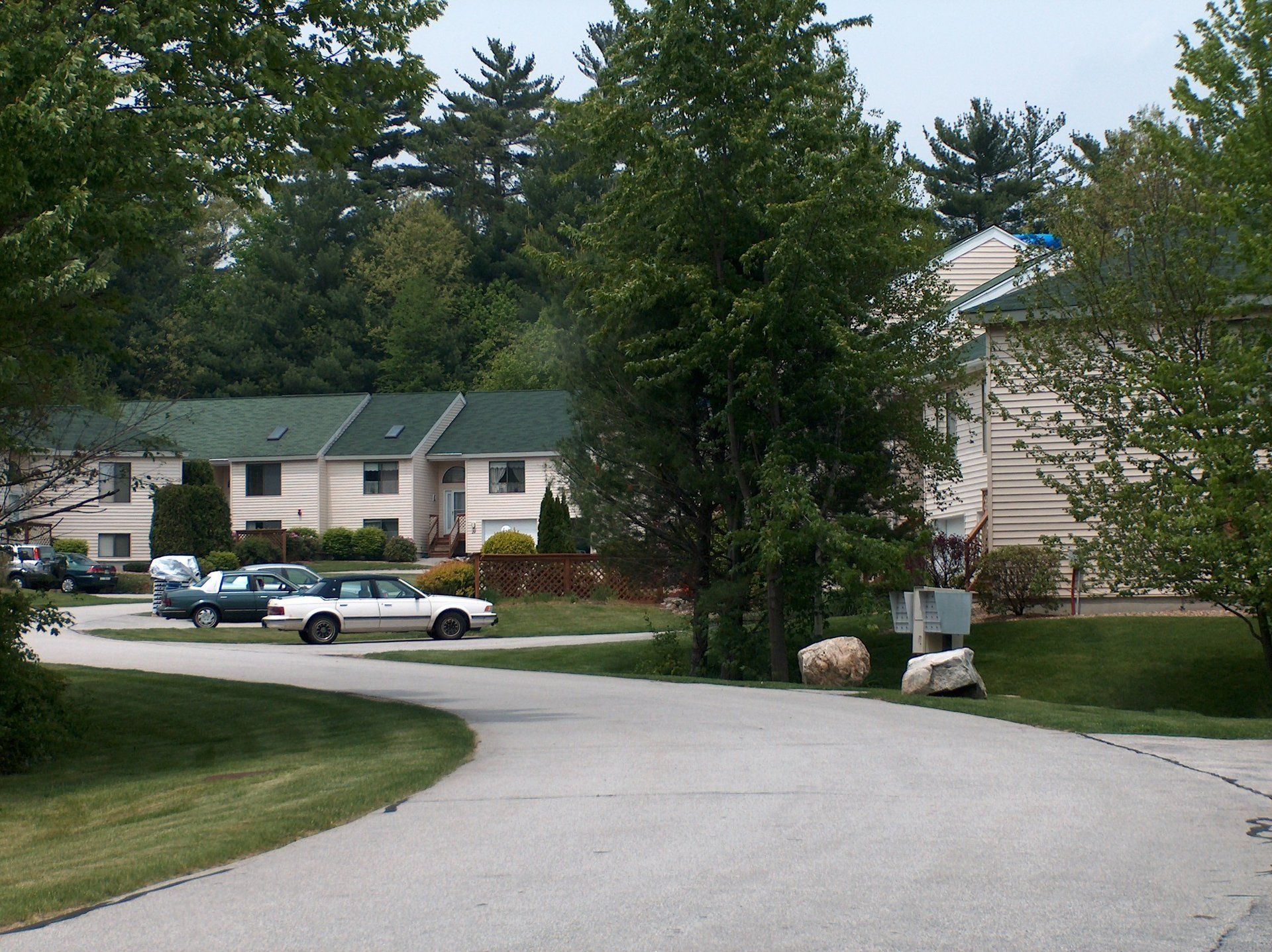 A white car is parked on the side of the road