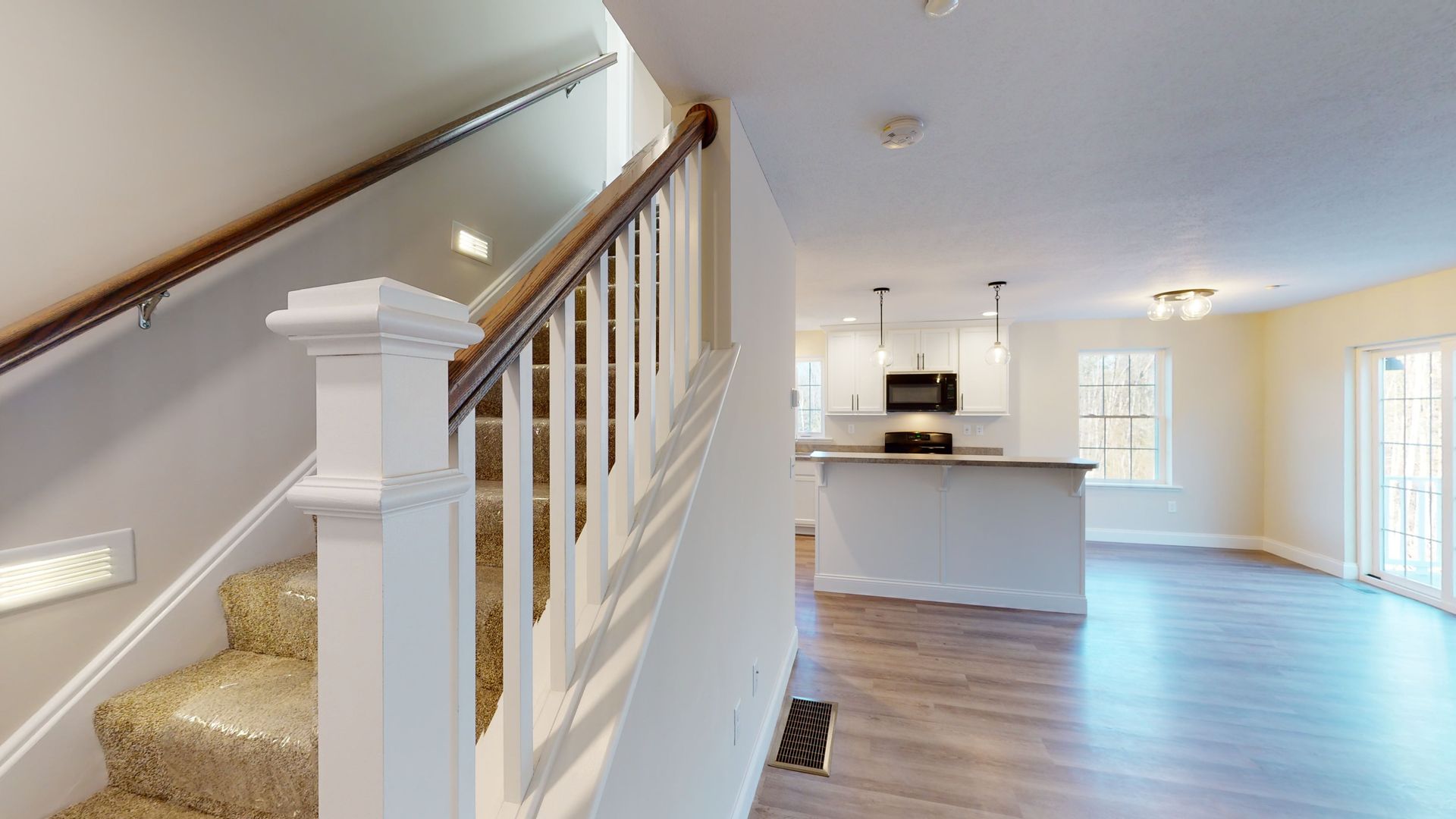 A 3d model of a house with stairs leading up to the second floor.