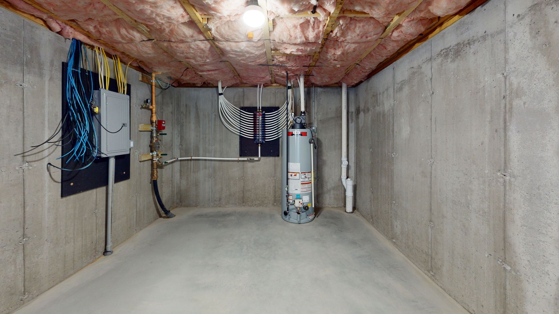 There is a water heater in the basement of a house.