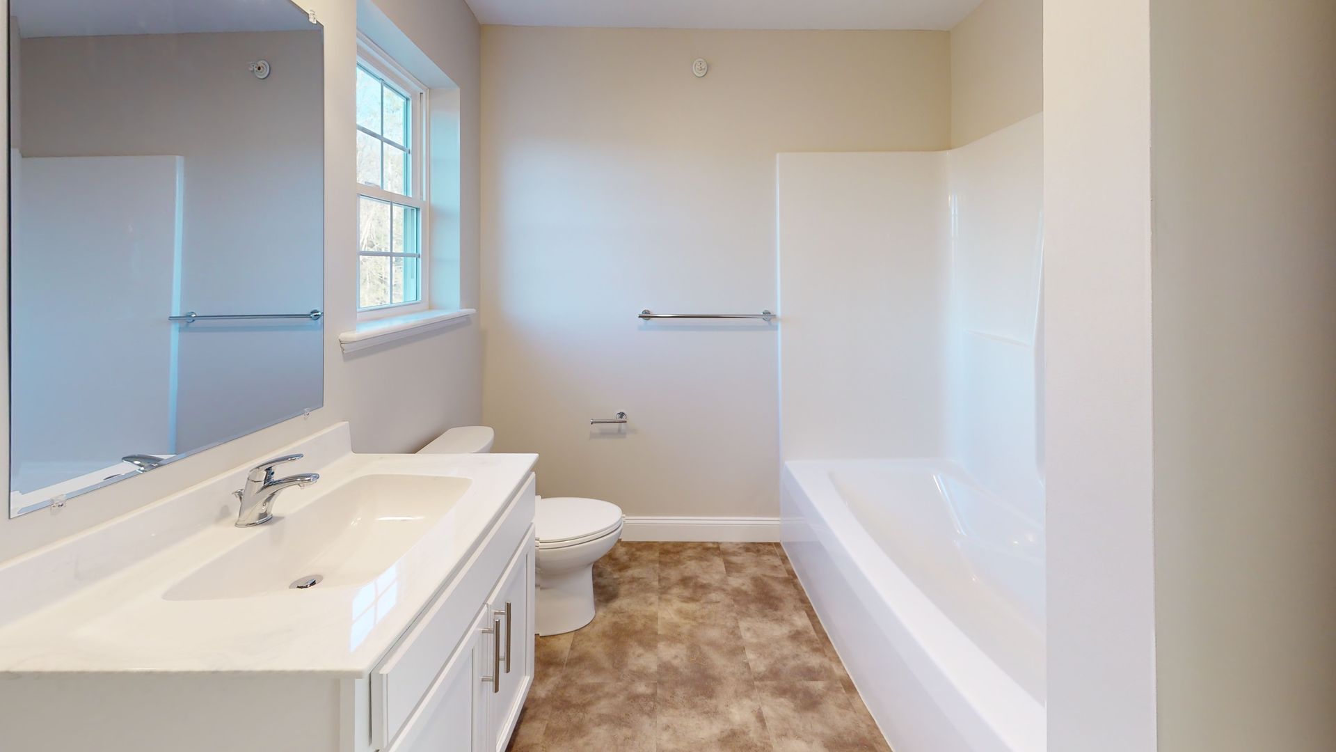 A bathroom with a sink , toilet , bathtub and mirror.