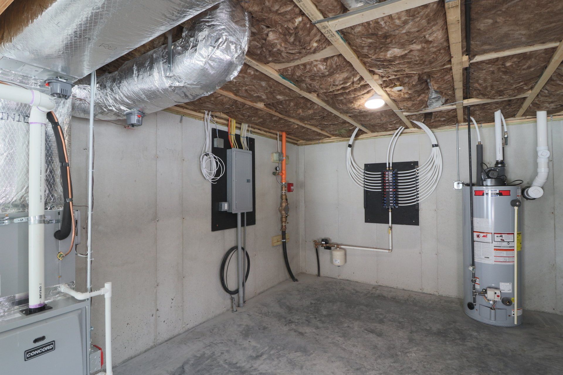 A basement with a water heater and a furnace.