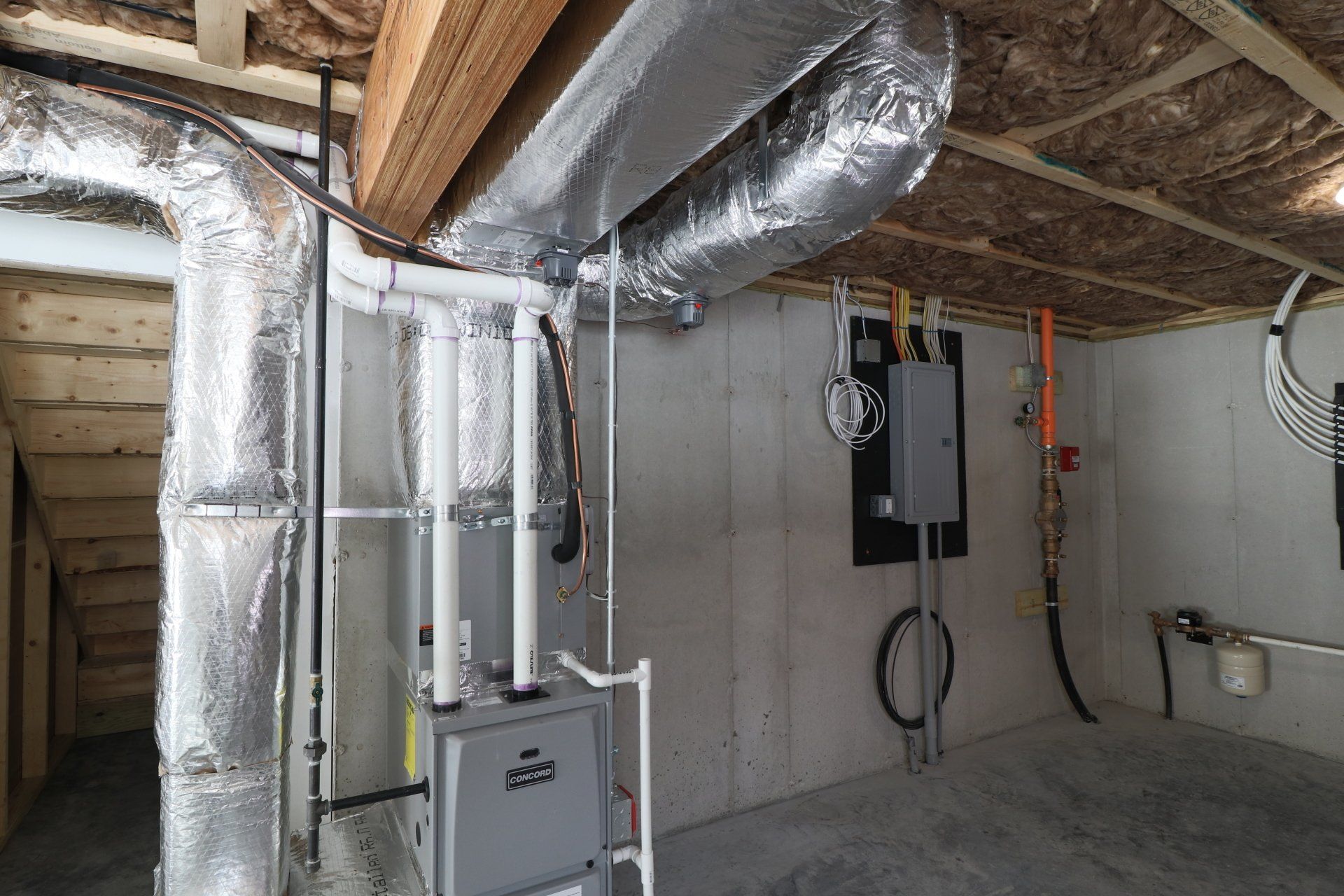 A basement with a lot of pipes coming out of it