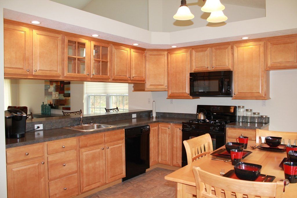 A kitchen with a table and chairs and a microwave