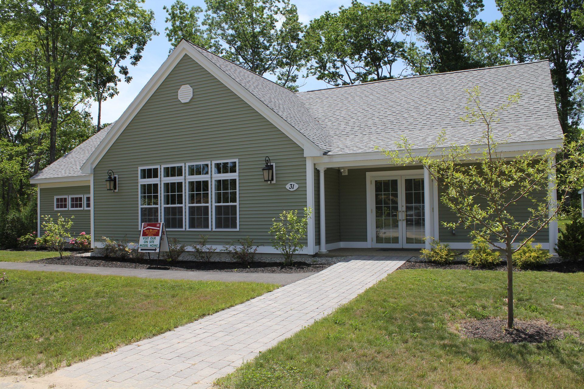 A house with a for sale sign in front of it