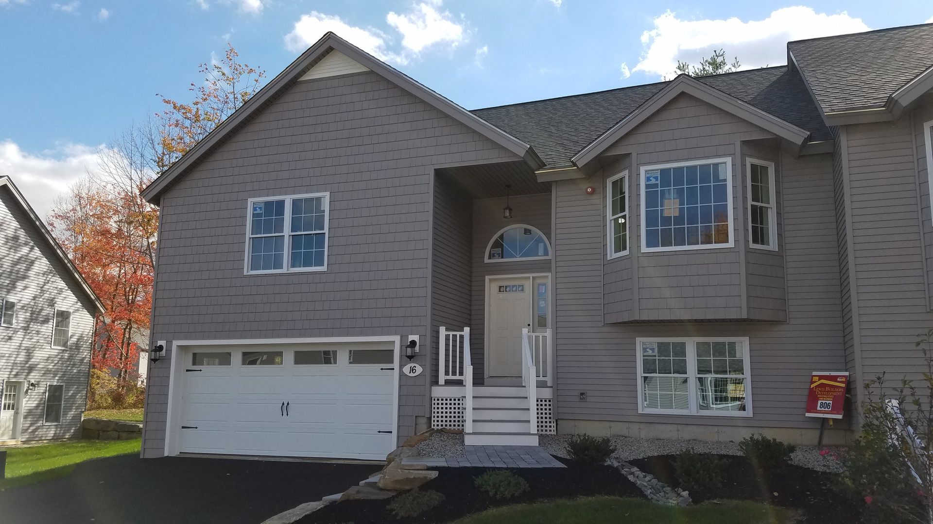 A large house with a garage and a lot of windows