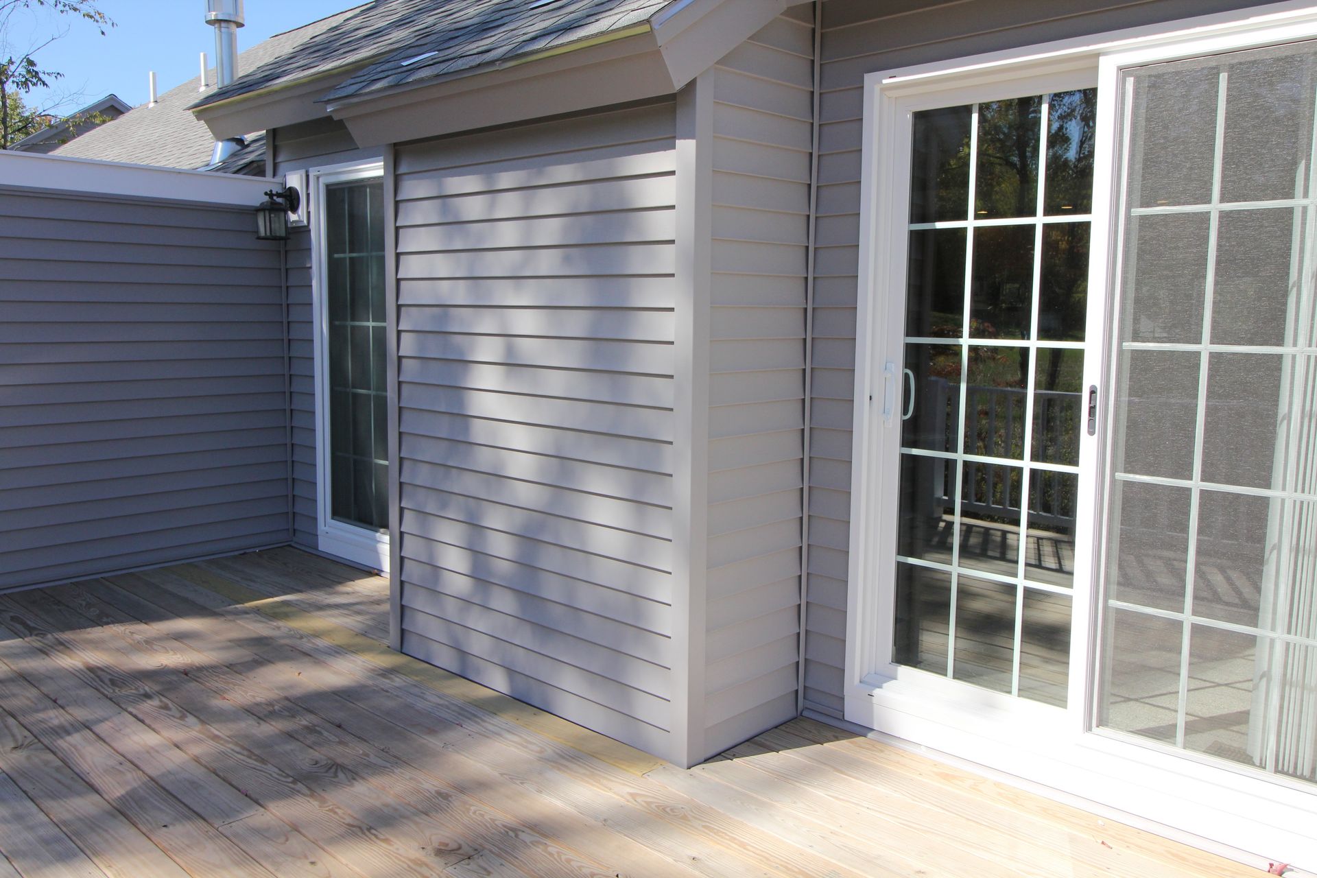 A house with a patio and sliding glass doors