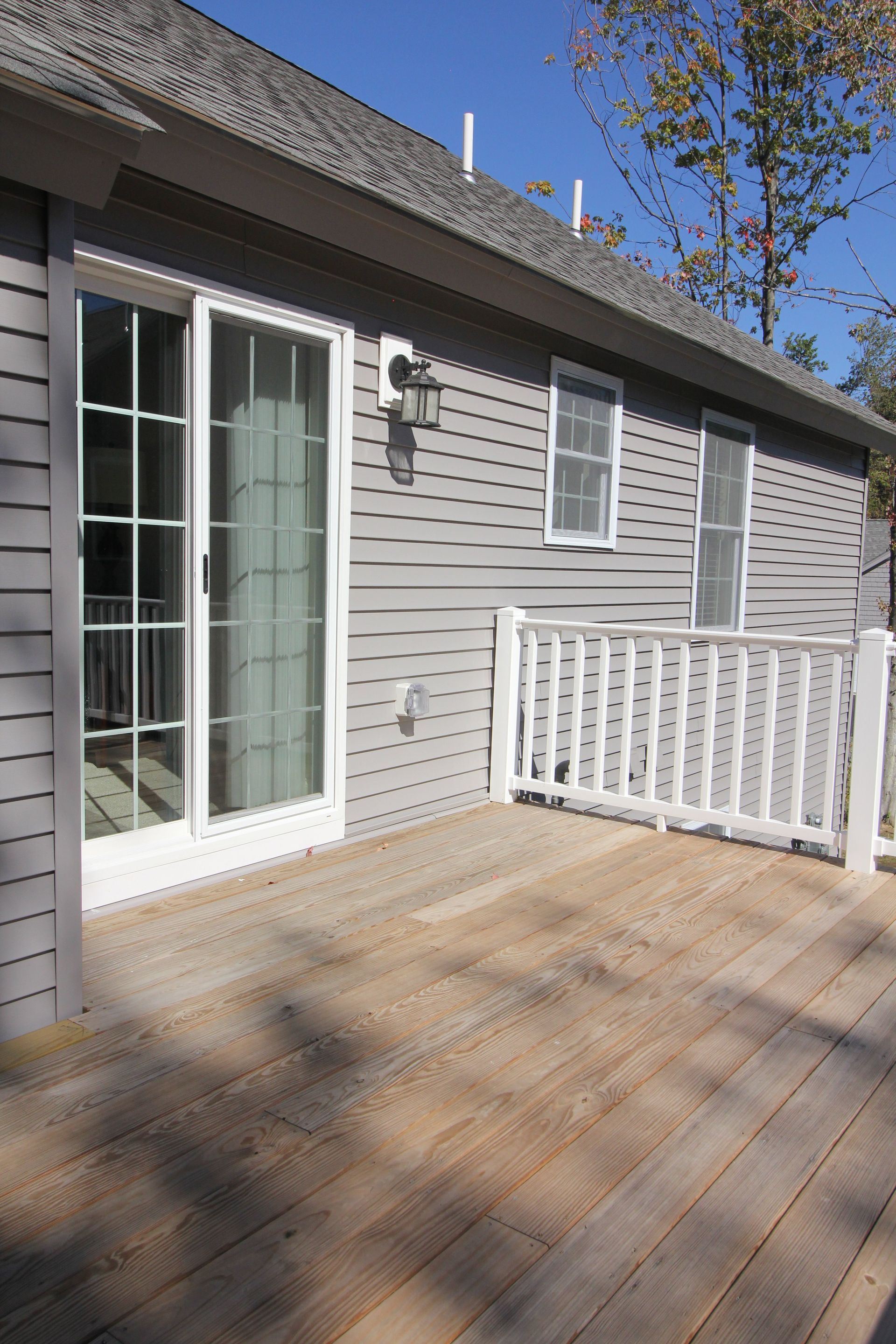 A house with a deck and sliding glass doors