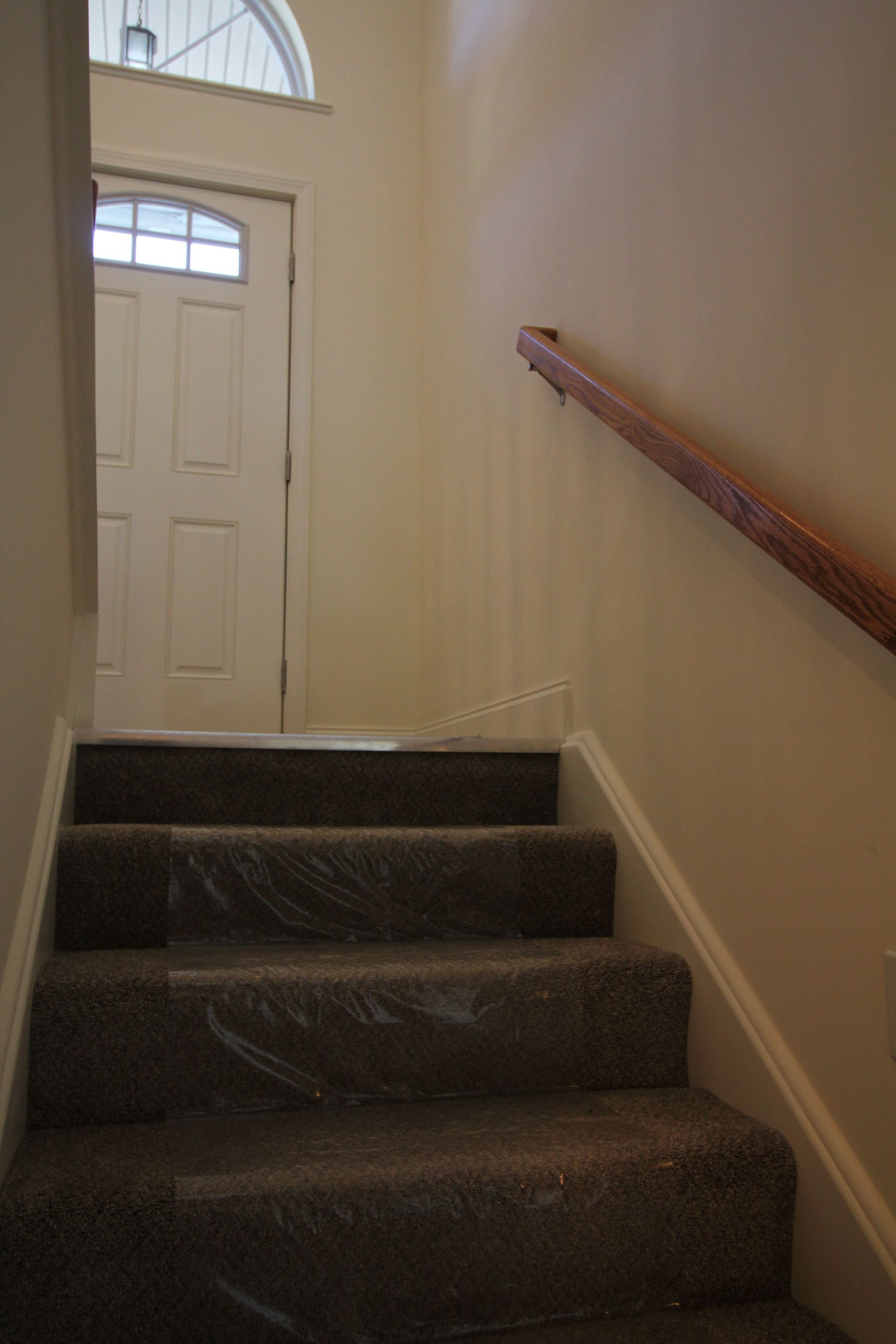 A set of stairs leading up to a door in a house.