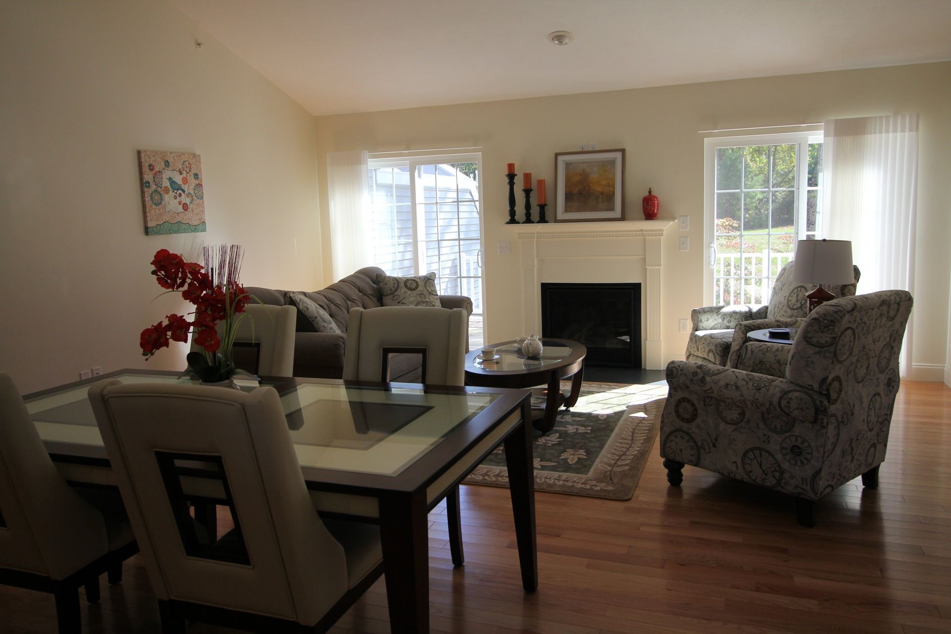 A living room with a table and chairs and a fireplace