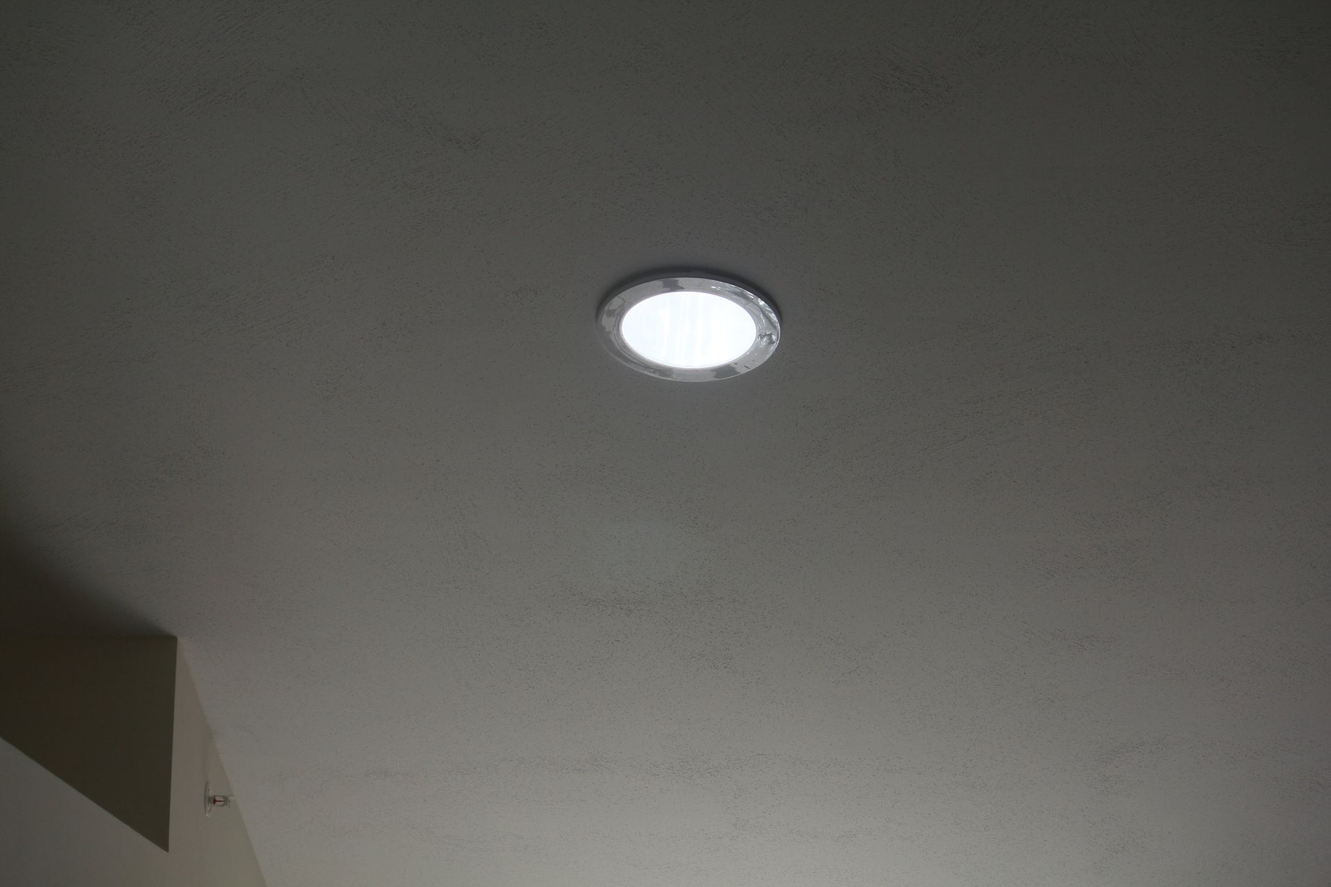 A light is shining through a hole in the ceiling.