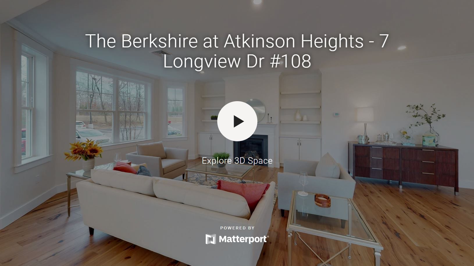 A living room with a couch , chairs , and a fireplace.