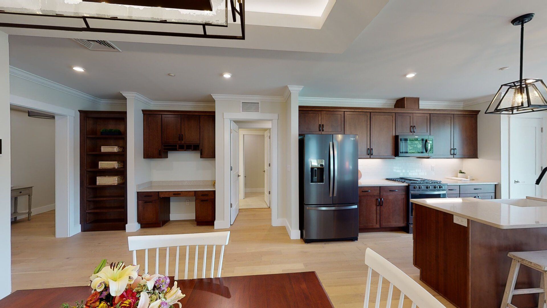 A kitchen and dining room in a house with a table and chairs.