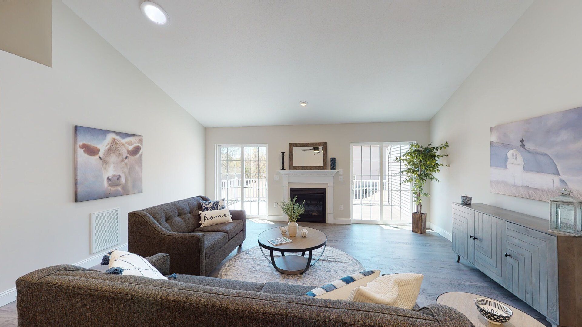 A living room with a couch , coffee table and fireplace.