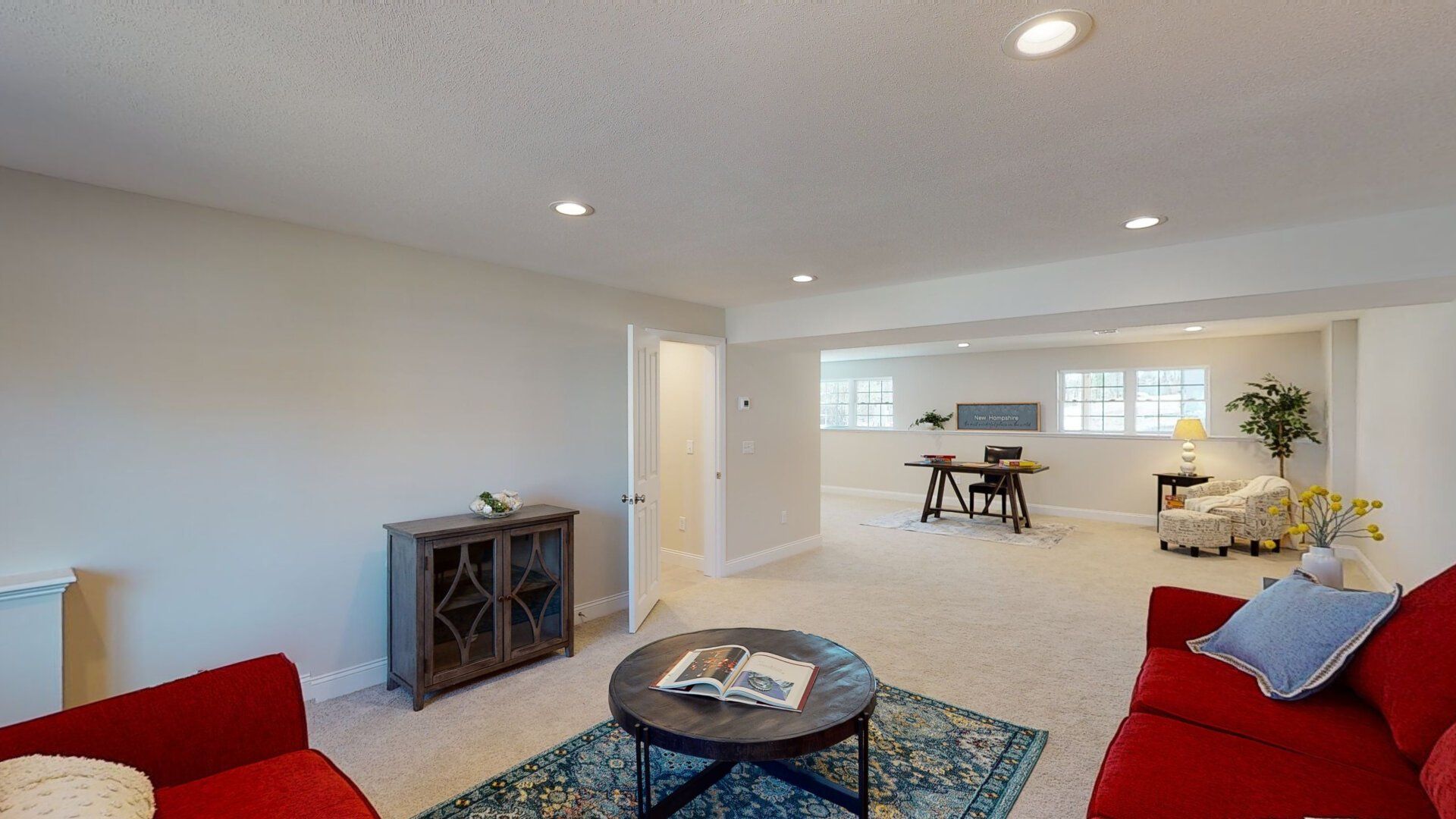 A living room with a red couch and a coffee table