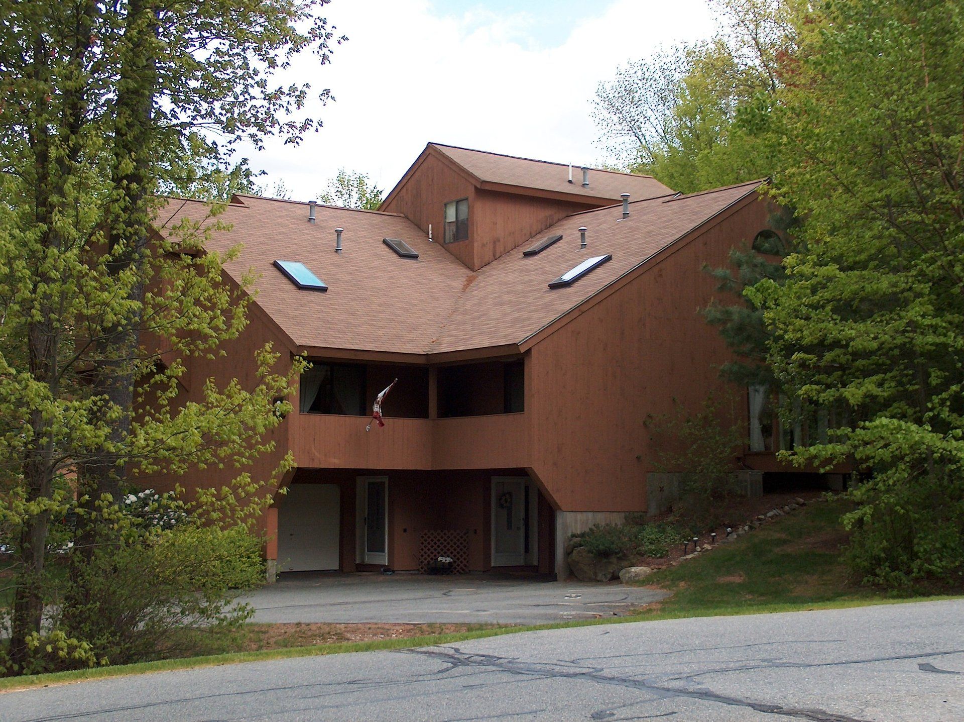 A large brick house with a roof that has skylights on it