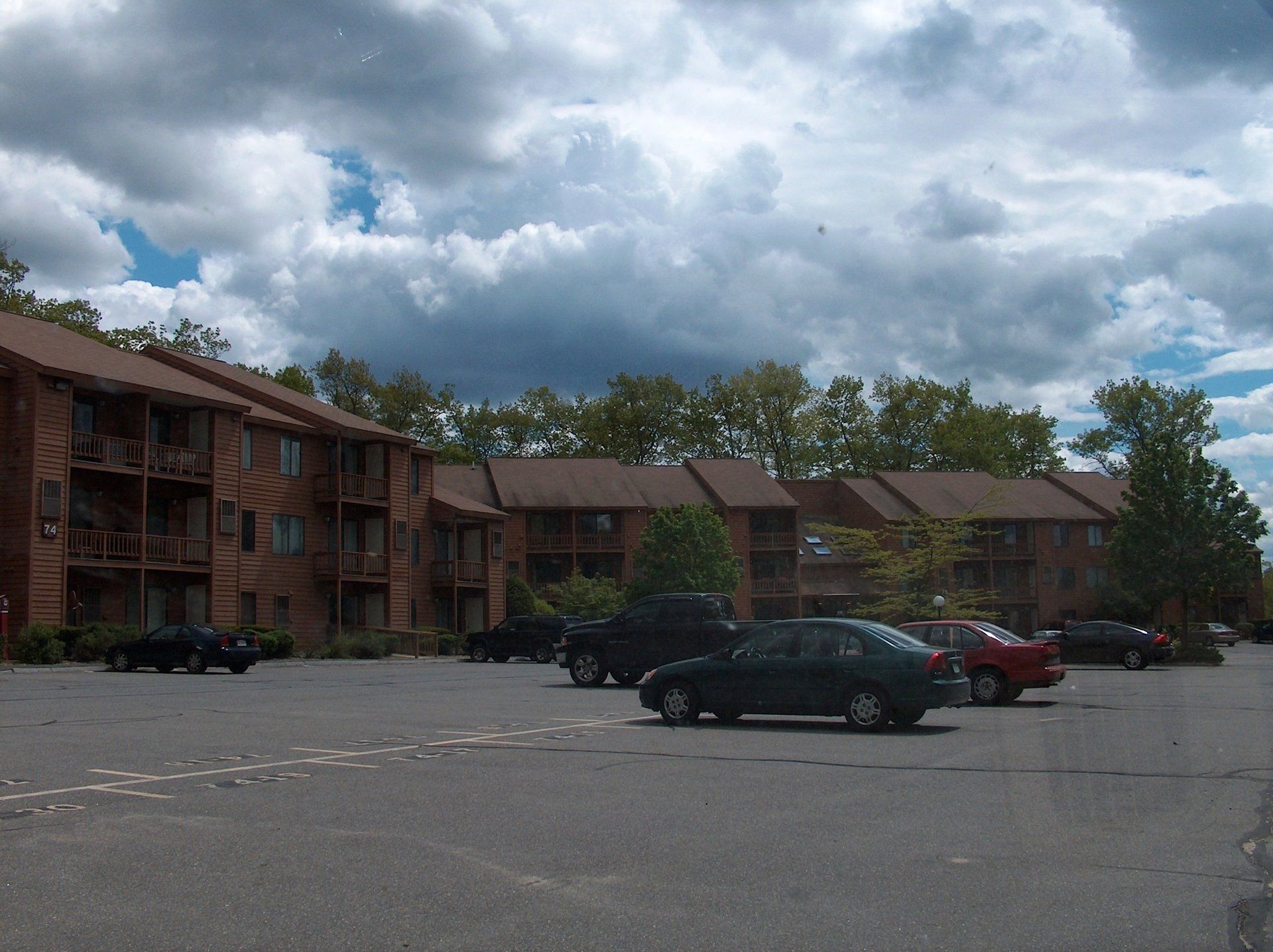 A parking lot with cars parked in front of a building