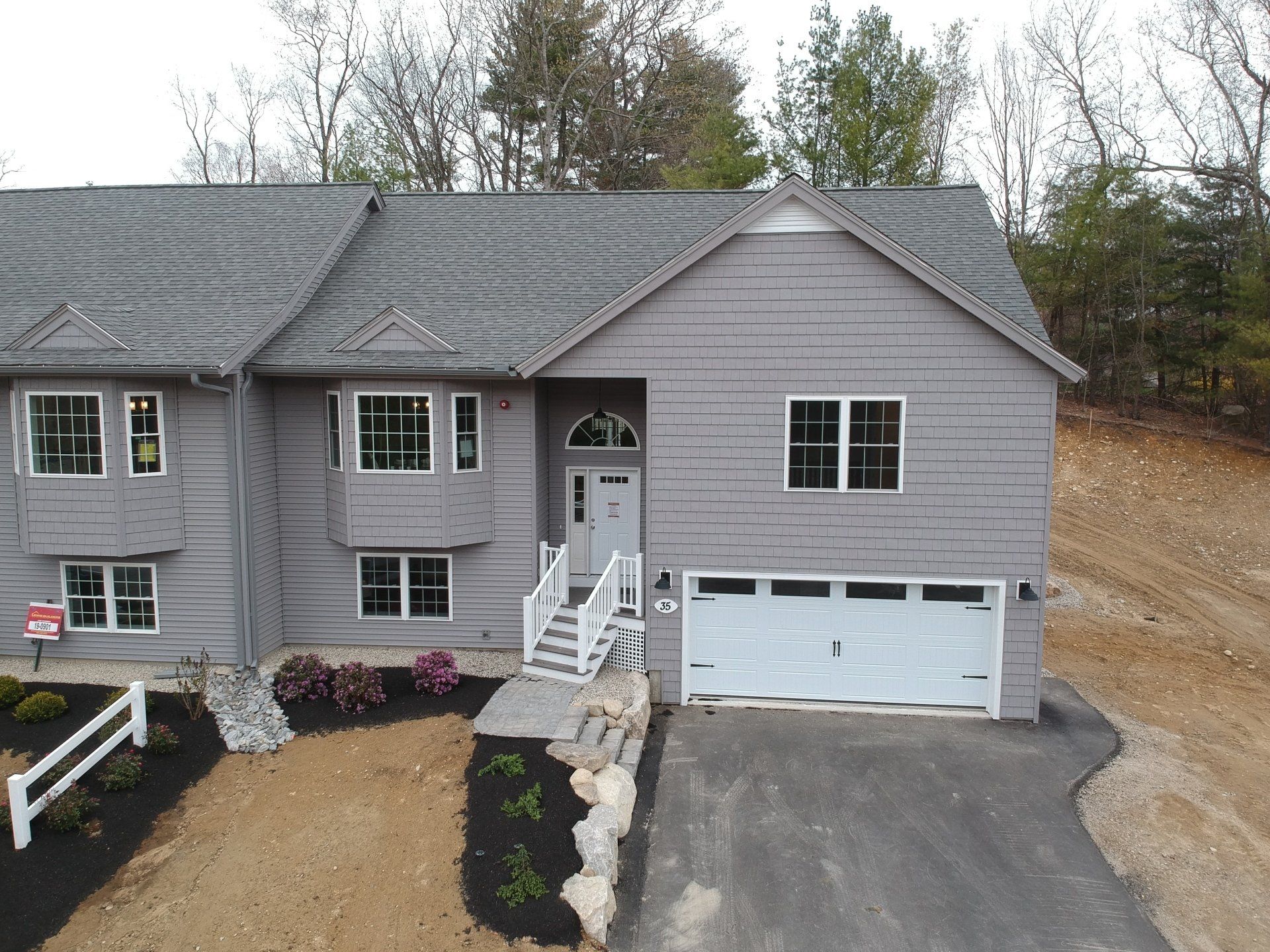An aerial view of a house with a blue garage door