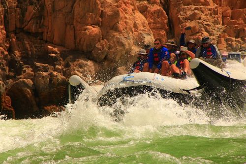A group of people are rafting down a river